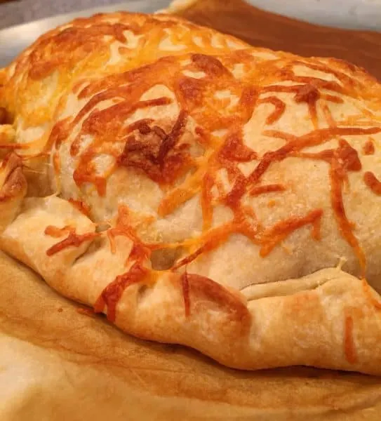 baked calzone on parchment paper