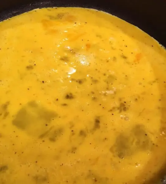 scrambled eggs cooking in skillet