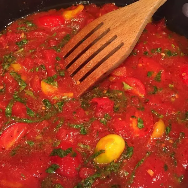 Adding seasonings and herbs to sauce 