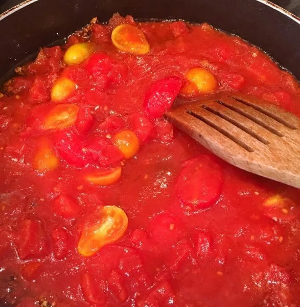 skillet full of tomato sauce ingredients