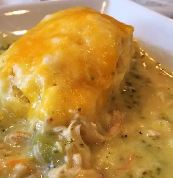 bowl full of broccoli soup with cheesy dumplings