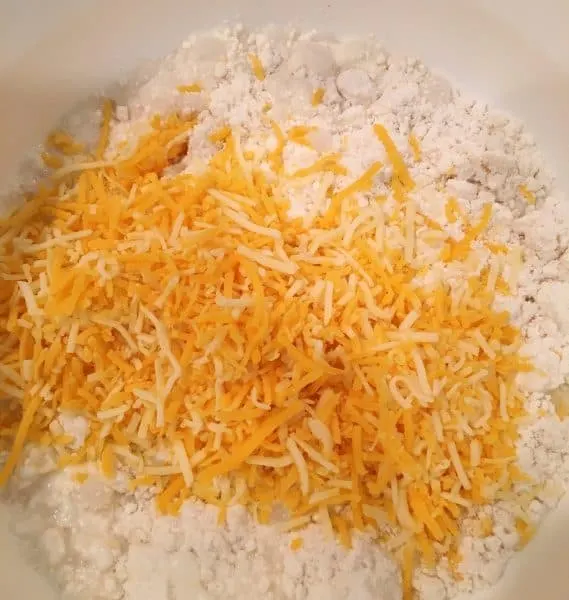 flour and biscuit ingredients with grated cheese