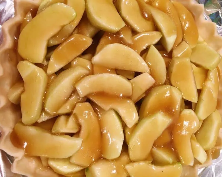 caramel sauce poured over slicing apples