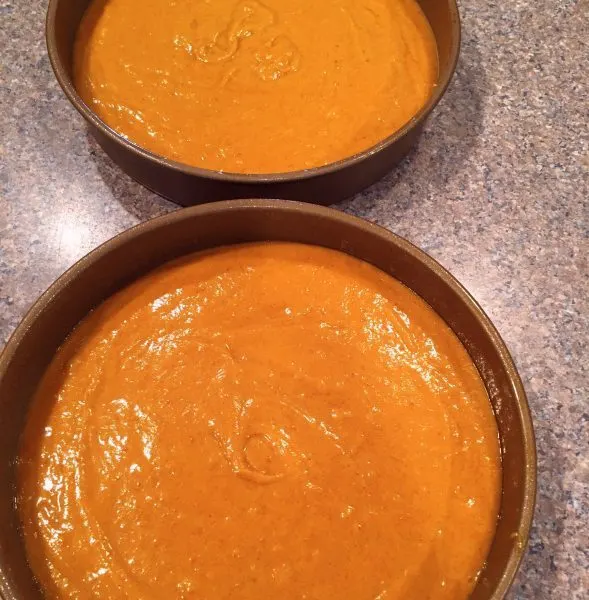 pumpkin cake batter in cake rounds ready to bake