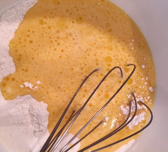 adding wet ingredients to dry cobbler batter