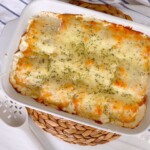 Baking dish with homemade alredo lasagna roll-ups.