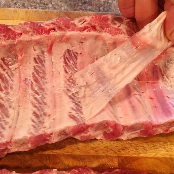 Pulling the membrane off the back of the baby back ribs 