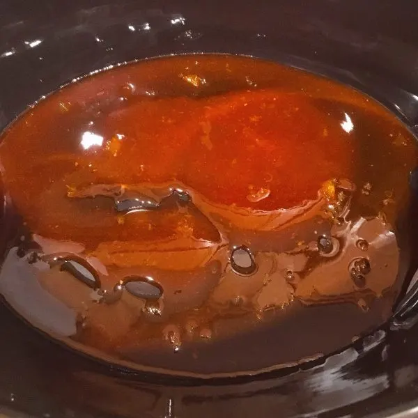 Honey Buffalo Sauce in the bottom of the slow cooker 