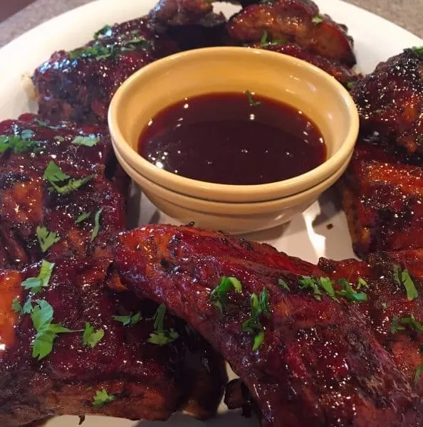 Honey Buffalo Ribs with extra sauce on a platter