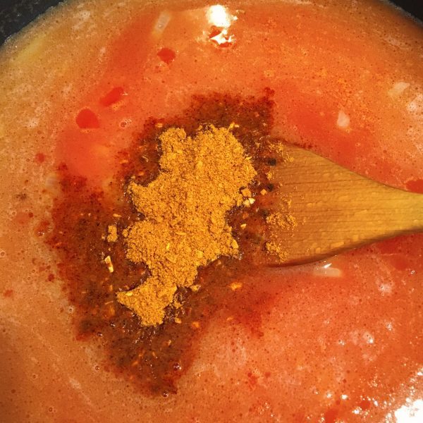 Adding chicken stock and taco seasoning to Spanish Rice