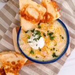 Chicken Enchilada Soup in a soup bowl with a golden crispy cheese quesadilla.