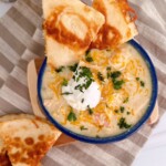 Chicken Enchilada soup with a golden crispy cheese quesadilla in a soup bowl.