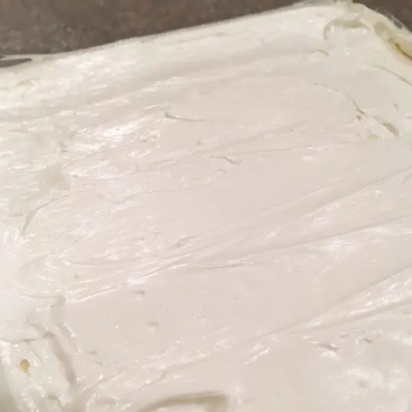 spreading cream cheese layer over crumb crust