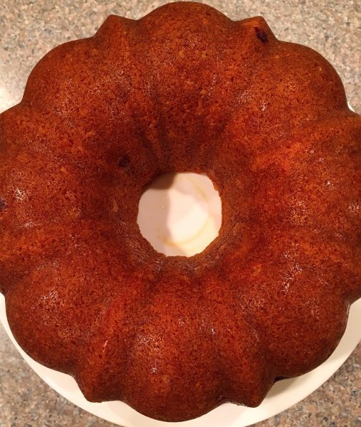 Cranberry Orange Bundt Cake on cake plate waiting for orange sauce