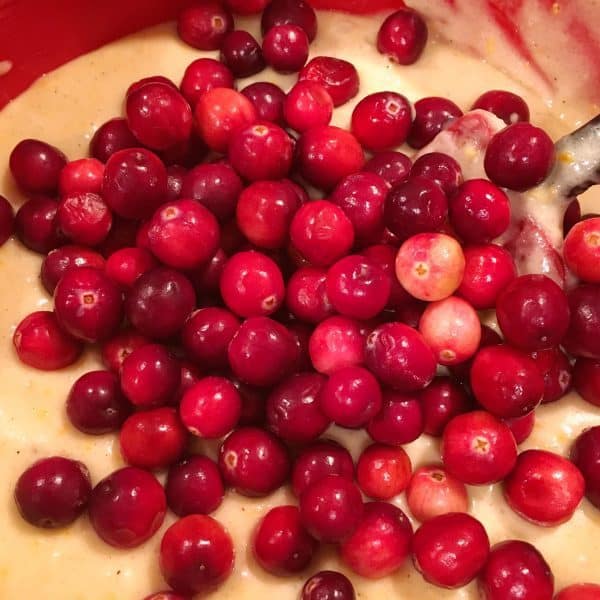 Adding whole fresh cranberries to orange cake batter