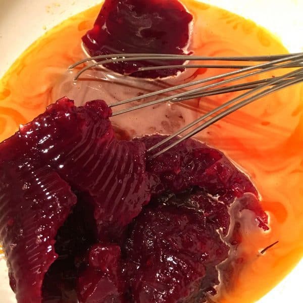 adding cranberry sauce to orange jello