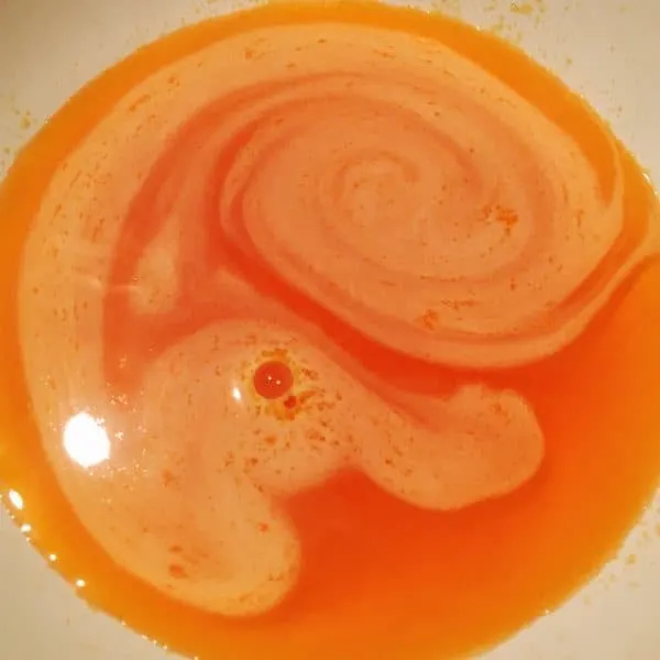 Orange jello mix in bowl