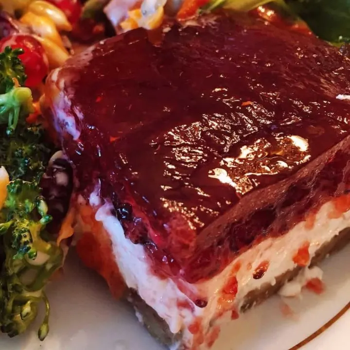 Cranberry orange jello salad on a dinner plate