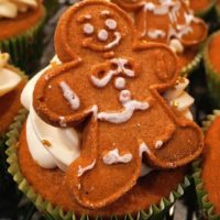 A cupcake with a gingerbread man on top
