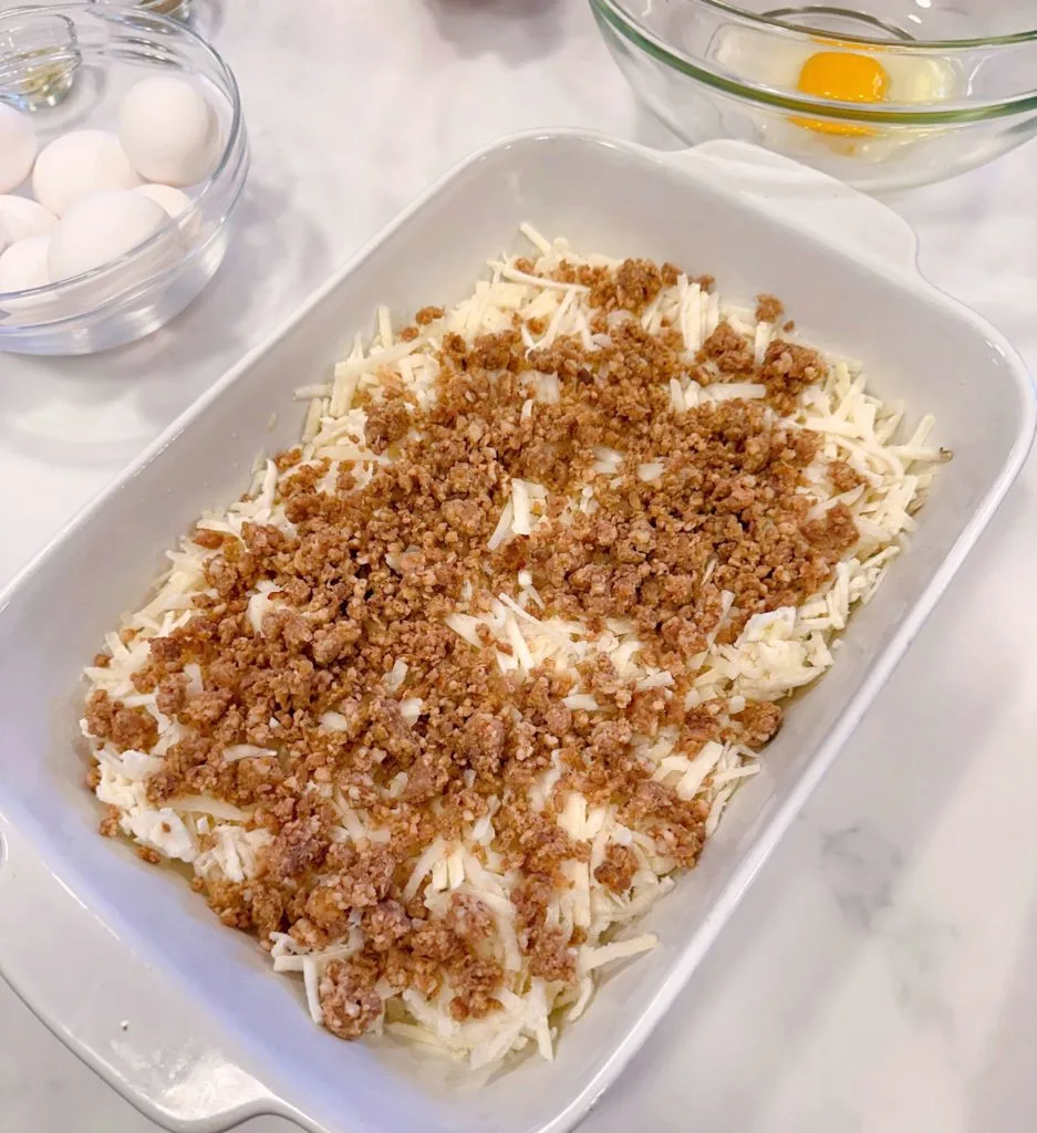 Cooked sausage on top of the hash browns.