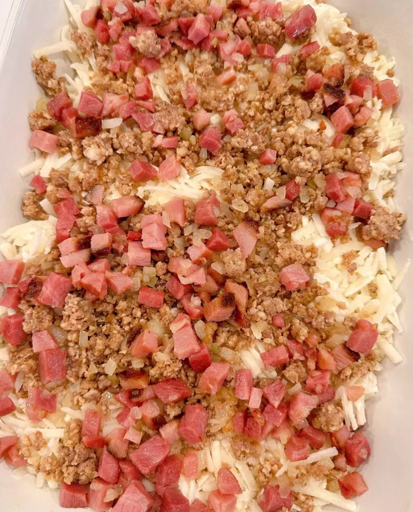 Adding ham and onions to the breakfast casserole.