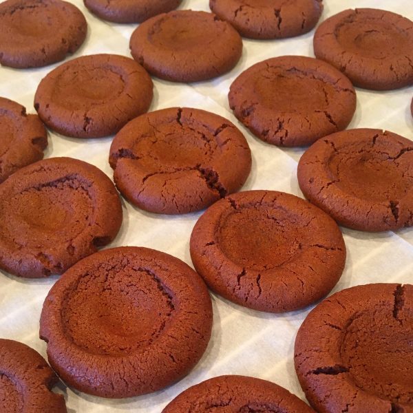 chocolate cookies baked with thumb print in the center for cherries