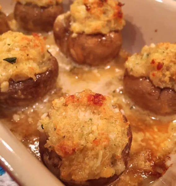Stuffed Crab Mushrooms baked to a golden crisp in a small casserole dish