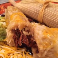 Homemade tamales with cheese on top
