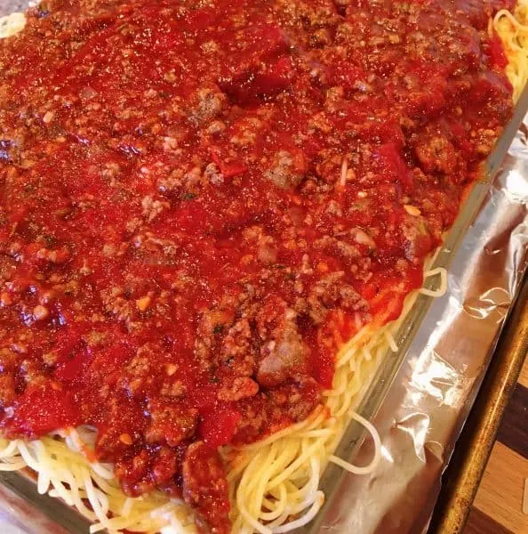Last layer of meat sauce on top of spaghetti for Baked Spaghetti