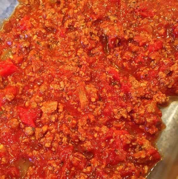 Meat sauce layering in the bottom of the casserole dish