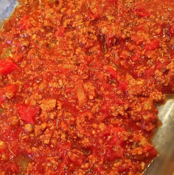 Meat sauce layering in the bottom of the casserole dish