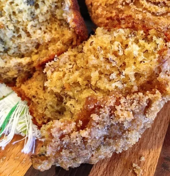 Banana crumb muffin broken in half and so moist and delicious
