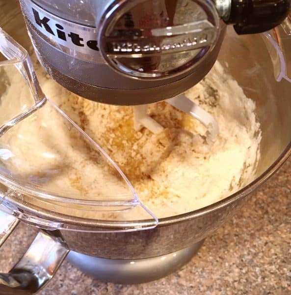 Adding flour to banana muffin batter