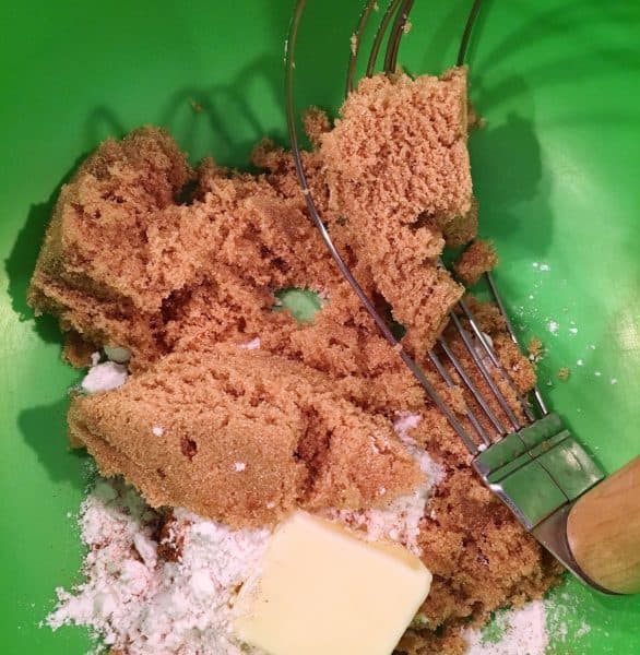 Crumb topping with pastry blender in bowl.