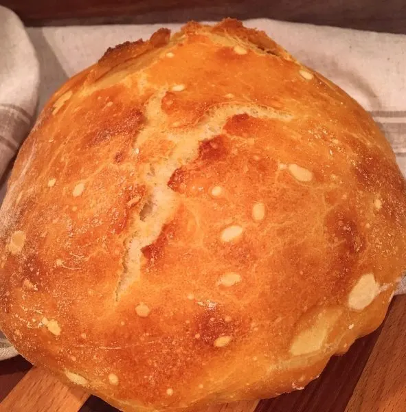 Beautiful golden brown Artisan bread on cutting board