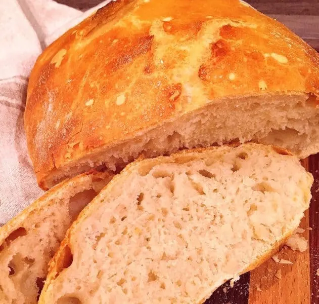 No knead Artisan Bread sliced on cutting board