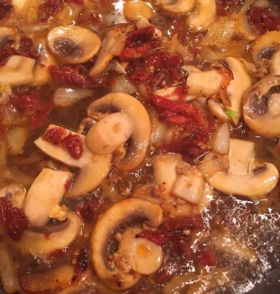 Addition of cooking wine to mushrooms and garlic