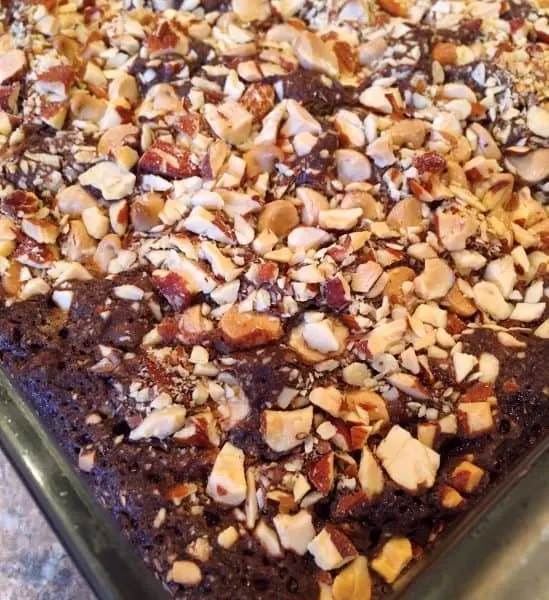 baked dark brownies with raspberries, white chocolate, and chopped almonds.