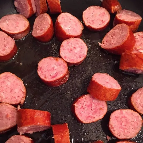 Cubed Beef Sausage in skillet cooking 