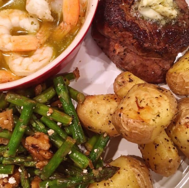 Dinner plate with Steak, Roasted Potatoes, Lemon Butter Shrimp, and asparagus side dish