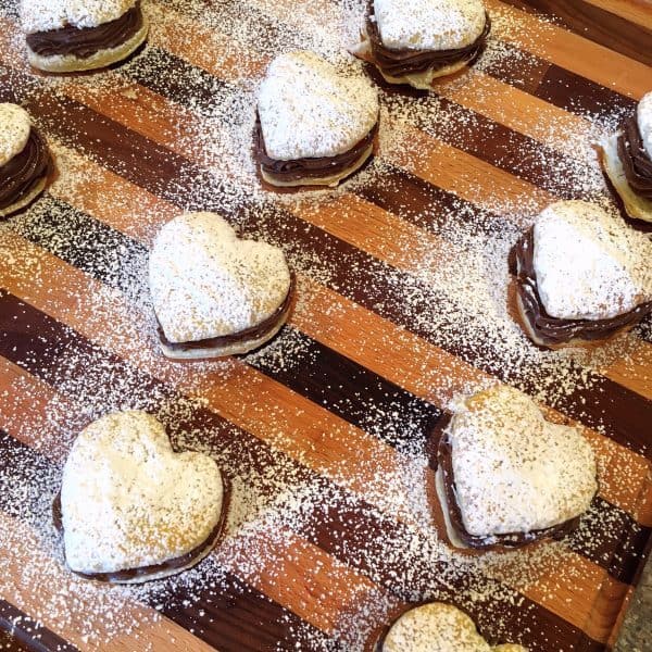 Heart puff pastries filled and sprinkled with powder sugar