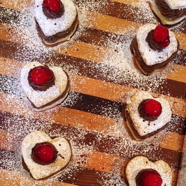 Chocolate Cherry Napoleons topped with chocolate whipped cream and a cherry