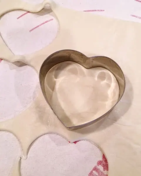 Puff Pastry Sheet with a heart shape cookie cutter cutting out the dough