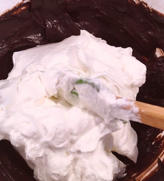 Chocolate Pudding with Whipped cream being folded in