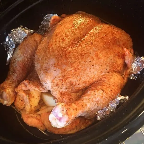 Whole chicken in the roasting pan and in the oven