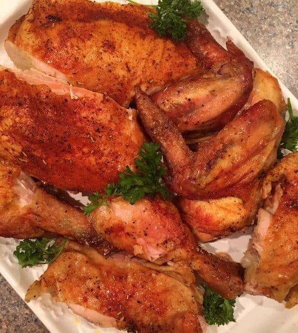 Platter full of cut up Roasted Rotisserie Style of chicken