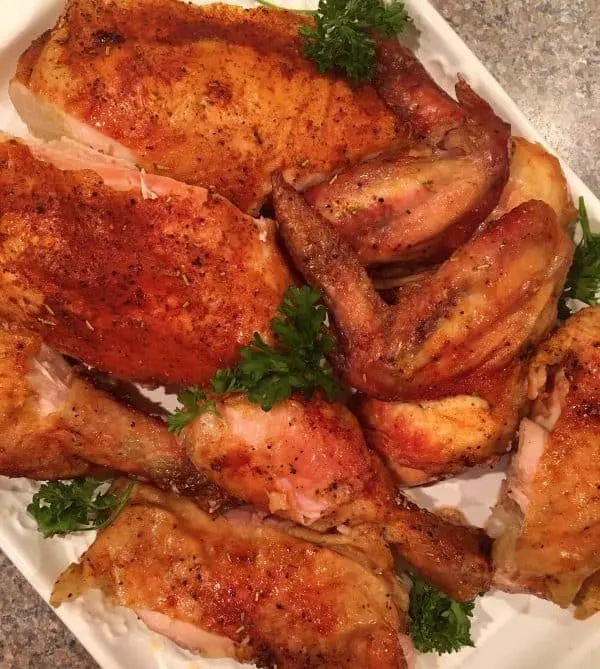 Platter full of cut up Roasted Rotisserie Style of chicken