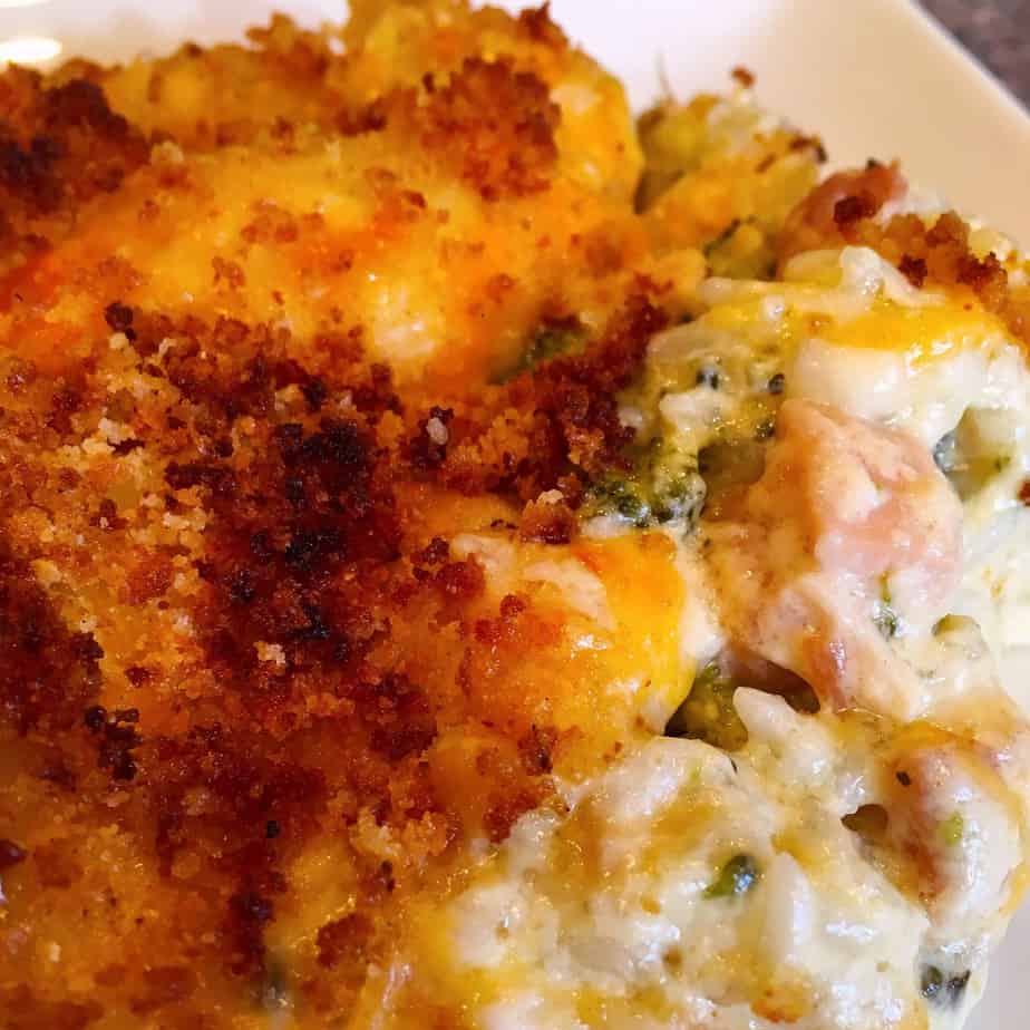 Creamy Rice and Chicken Broccoli Casserole topped with cheese and toasted buttery bread crumbs