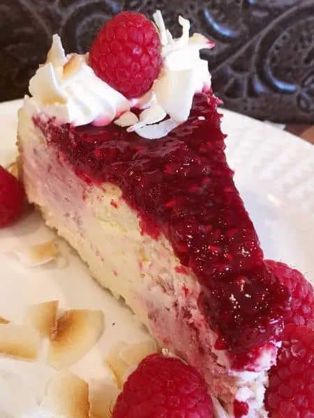 Slice of Coconut Raspberry Cheesecake with beautiful Raspberry swirls