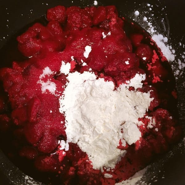 Medium Sauce Pan with thawed raspberries, sugar, and corn starch for Coconut Raspberry Cheesecake
